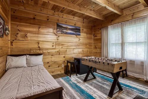 a bedroom with a bed and a foosball table at Stairway To Heaven By Beyond Expectations in Sevierville