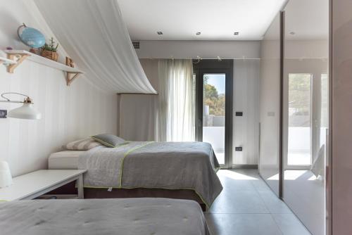 Ένα ή περισσότερα κρεβάτια σε δωμάτιο στο Villa Soligia Helios