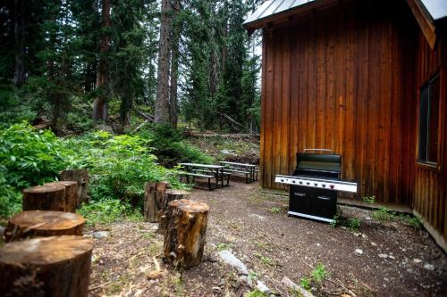 a piano sitting in front of a wooden building at Cabin on the Edge of Forever in Brighton