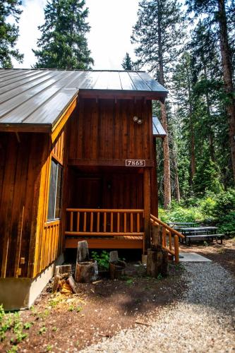 a cabin in the woods with a sign on it at Cabin on the Edge of Forever in Brighton