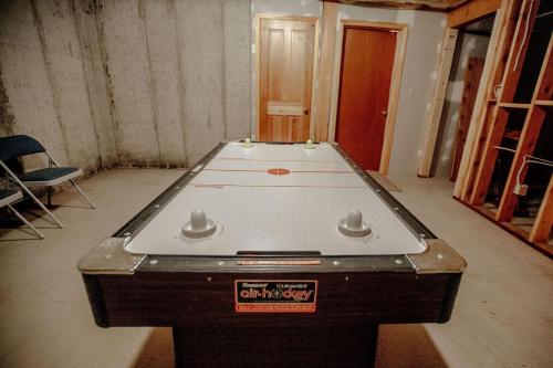 a ping pong table in the middle of a room at Cabin on the Edge of Forever in Brighton