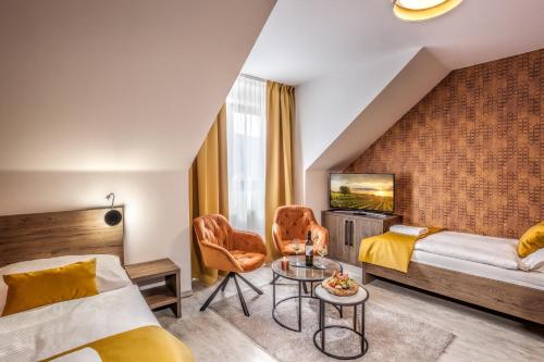 a hotel room with a bed and a table at Hotel Beta in Bzenec