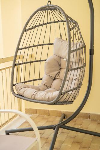a bird cage with a pillow in it at Domus Suite Herculaneum jacuzzi in Ercolano