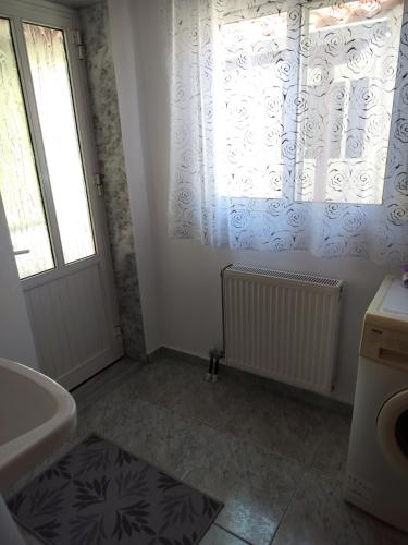 a bathroom with a tub and a sink and a window at ilkay's House in Mákri