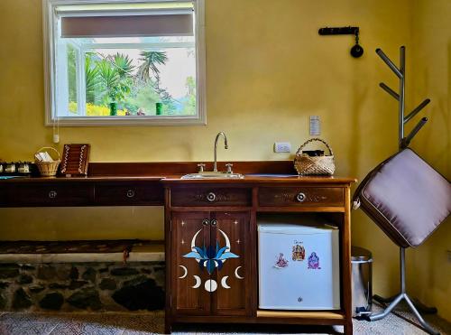 a wooden sink in a room with a window at Twelve Hummingbirds Andes Retreat in Paute