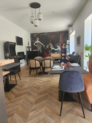 a living room with tables and chairs and a couch at Chambres hote Le Clos 26 in Bellerive-sur-Allier