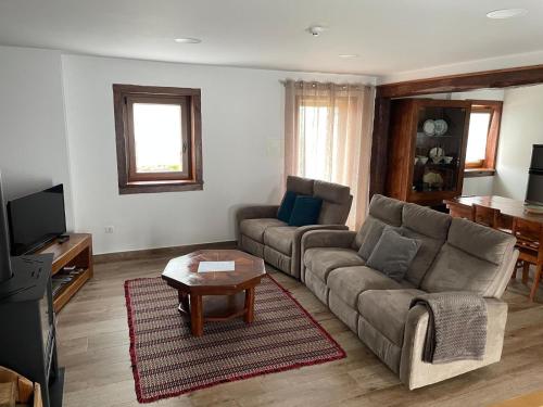 a living room with a couch and a table at Casa de Xisto Ti Lucília in Videmonte
