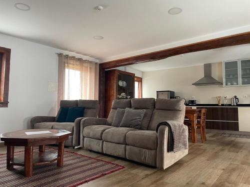 a living room with a couch and a table at Casa de Xisto Ti Lucília in Videmonte