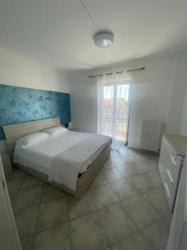 a bedroom with a bed and a large window at Lecasedialex it Casa thas in La Loggia