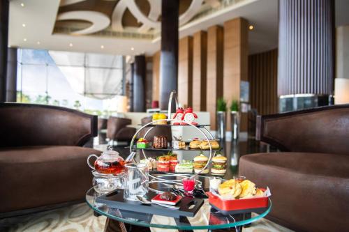 a tray of food on a table in a restaurant at Marriott Hotel Al Forsan, Abu Dhabi in Abu Dhabi