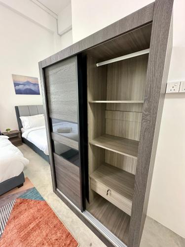 a closet in a room with a bed at Ferringhi Inn 51 in Batu Ferringhi