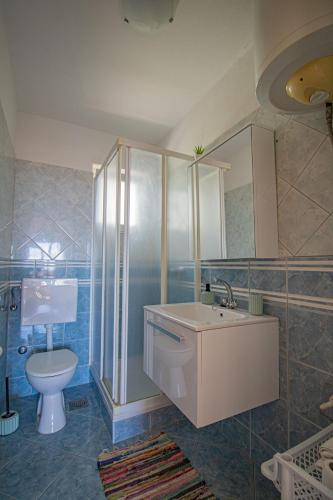 a bathroom with a sink and a toilet at Apartments Petar Maksan in Pakoštane