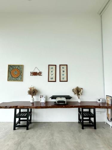 a wooden table in a room with two benches at Ferringhi Inn 51 in Batu Ferringhi