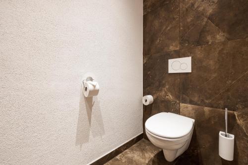 a bathroom with a white toilet in a room at Wildkogel Resorts - DAS Bramberg in Bramberg am Wildkogel