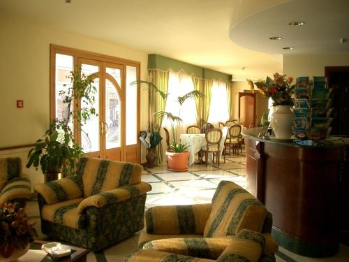a living room filled with furniture and a large window at Hotel Stella 2000 in Olbia