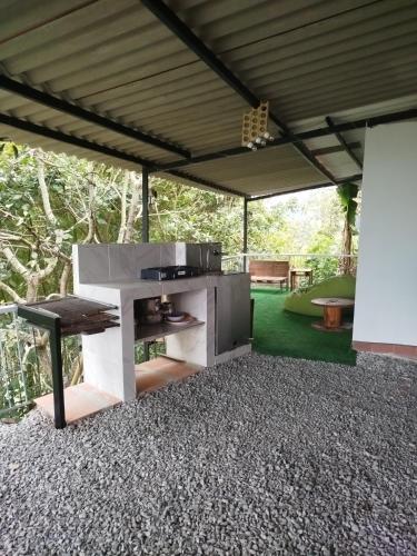 a kitchen under a tent with a table in a yard at Mountain View Hostel in Manizales
