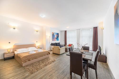 a bedroom with a bed and a living room at Alpine Escape Studio - Silver Mountain Resort & SPA - Poiana Brasov in Poiana Brasov