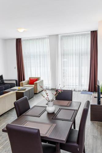 a living room with a table and a couch at Alpine Escape Studio - Silver Mountain Resort & SPA - Poiana Brasov in Poiana Brasov