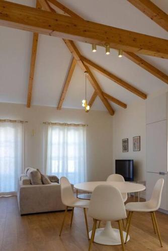 a living room with a couch and a table and chairs at Casa Galvão Arcos de Valdevez in Arcos de Valdevez