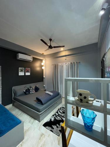 a living room with a bed and a table at River View Homestay in Dibrugarh