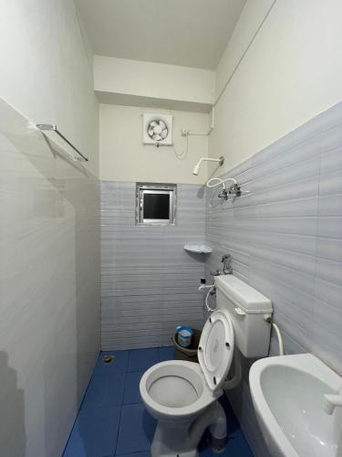 a bathroom with a toilet and a sink at River View Homestay in Dibrugarh