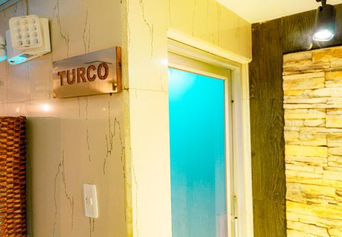 a sign on a wall next to a door at Park Hotel in Tulcán