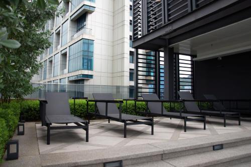 a table and chairs in front of a building at 5 Mossaz Muji 2 room at Empire City by Light House in Petaling Jaya