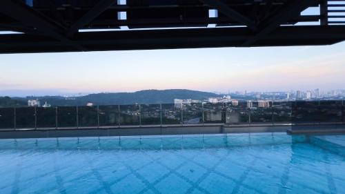 a large swimming pool on the roof of a building at 5 Mossaz Muji 2 room at Empire City by Light House in Petaling Jaya