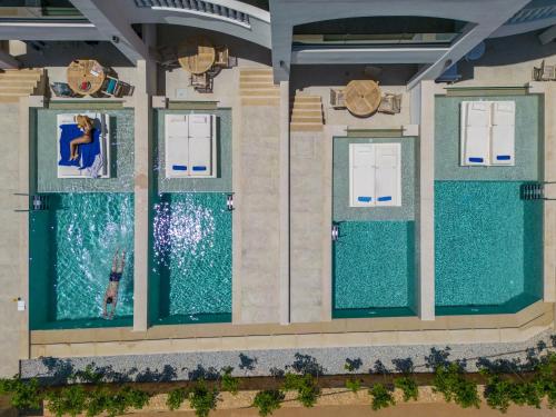 an overhead view of a pool at a resort at Parthenis Beach, Suites by the Sea in Malia