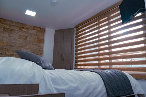 a bedroom with a bed and a large window at Park Hotel in Tulcán