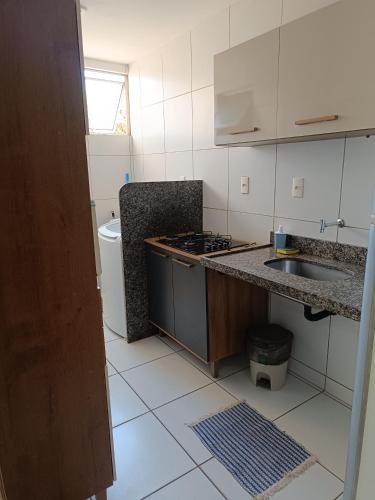 a kitchen with a sink and a stove top oven at AP 102 Acolhedor situado na Zona Leste, com 3 quartos sendo 1 suíte in Teresina