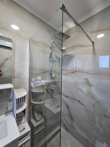 a shower with a glass door in a bathroom at Hotel Mažijanik in Nikšić