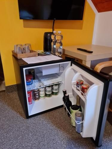 a small refrigerator with its door open in a room at Sněžník in Sněžnik