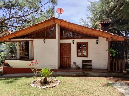 a small white house with a wooden roof at Travels in Mazamitla