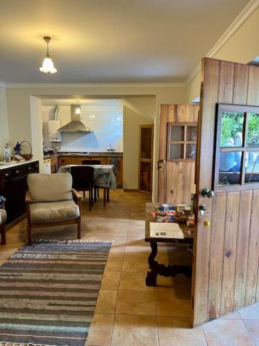 a living room with a table and a kitchen at Villa with Mountain view, São Vicente, Madeira in São Vicente