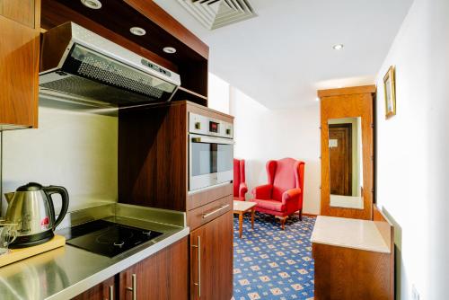 a kitchen with a stove top oven in a room at Om Kolthoom Hotel in Cairo