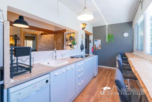 a bathroom with a sink and a counter at Beautiful Villa Encanto with private pool in Olivella