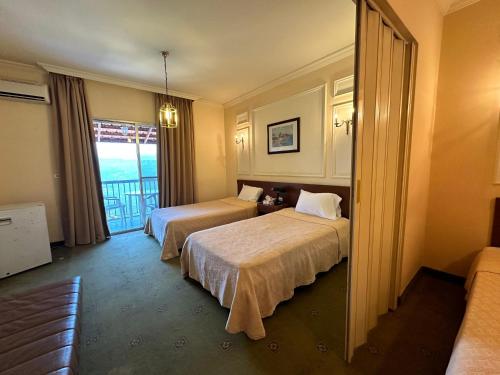 a hotel room with two beds and a window at Le Crillon in Broummana