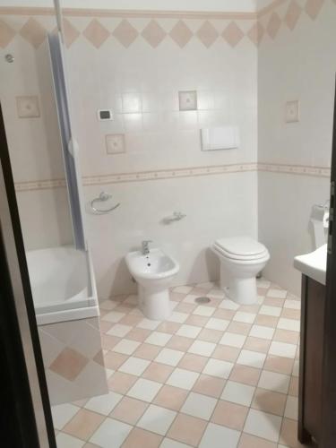 a bathroom with a toilet and a sink at Al Carpine in Roccadaspide