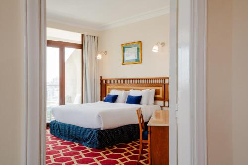 a hotel room with a bed and a window at Om Kolthoom Hotel in Cairo