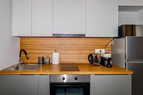 a kitchen with a sink and a counter top at Cozy Studio in the City Center in Thessaloniki