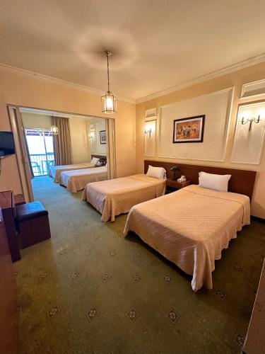 a hotel room with two beds and a window at Le Crillon in Broummana