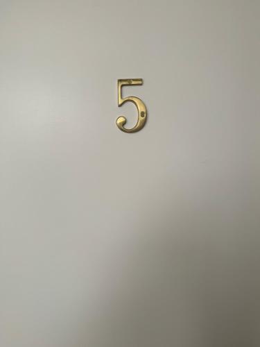 a number five on a white wall at Apartamento Alfama - Lisbon in Lisbon