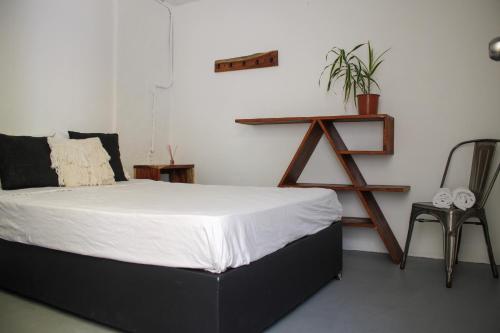 a bedroom with a bed and a wooden shelf at The Boat House Cancun in Cancún
