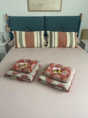 a bed with two pillows on top of it at Benidorm Beach Belluba luxury bay in Benidorm