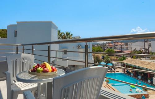 a bowl of fruit on a table on a balcony at Economisa Apartments in Ialyssos