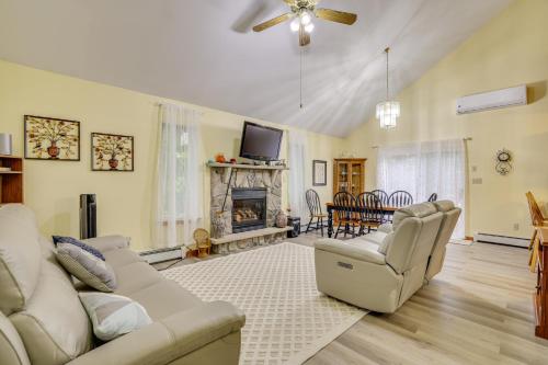 a living room with a couch and a fireplace at Private Hot Tub Lakefront Poconos Home! in Pocono Summit