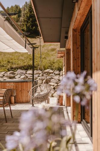 a porch with a swing and flowers on a building at Rycerki Dom na Szlaku in Rajcza