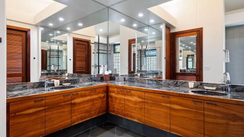 un bagno con due lavandini e un grande specchio di Kona Bay Estates 23 a Kailua-Kona