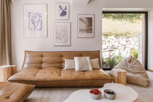 a living room with a brown leather couch at Rycerki Dom na Szlaku in Rajcza